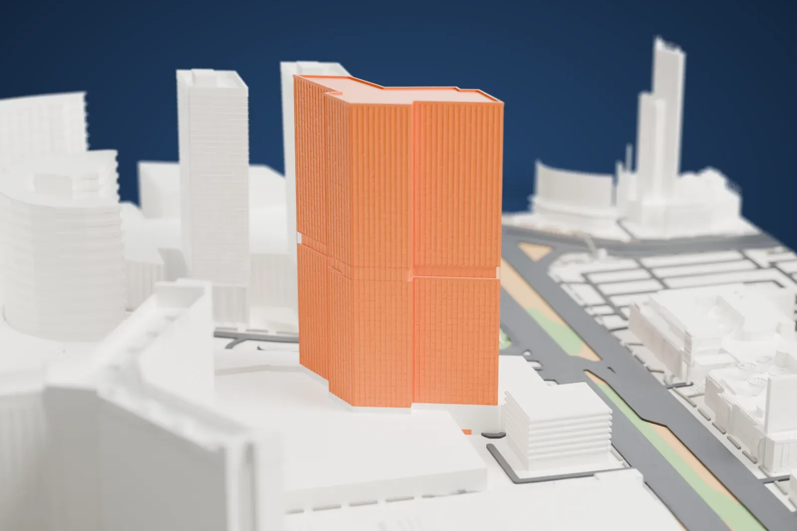 A white 3D print of the Waldorf Astoria Las Vegas, a tall tower with a stepped roof and ribbed facade, standing among neighboring towers and low buildings beside wide roads.