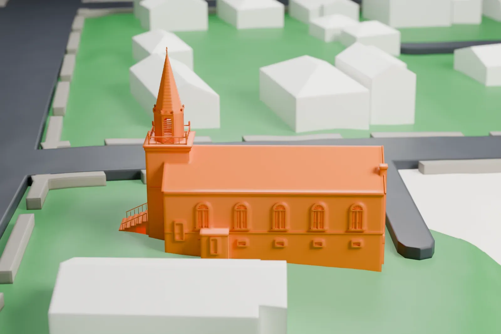 A white 3D print of a church with a gabled roof and a tall spire, surrounded by houses and lawns.