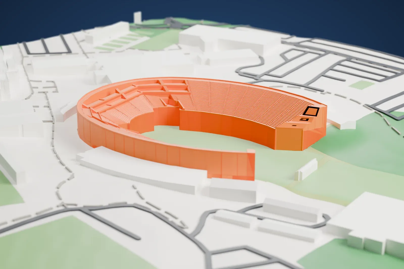 A white 3D print of the Wallace Wade Stadium with a curved seating bowl open at one end, surrounding buildings, roads, and open fields.