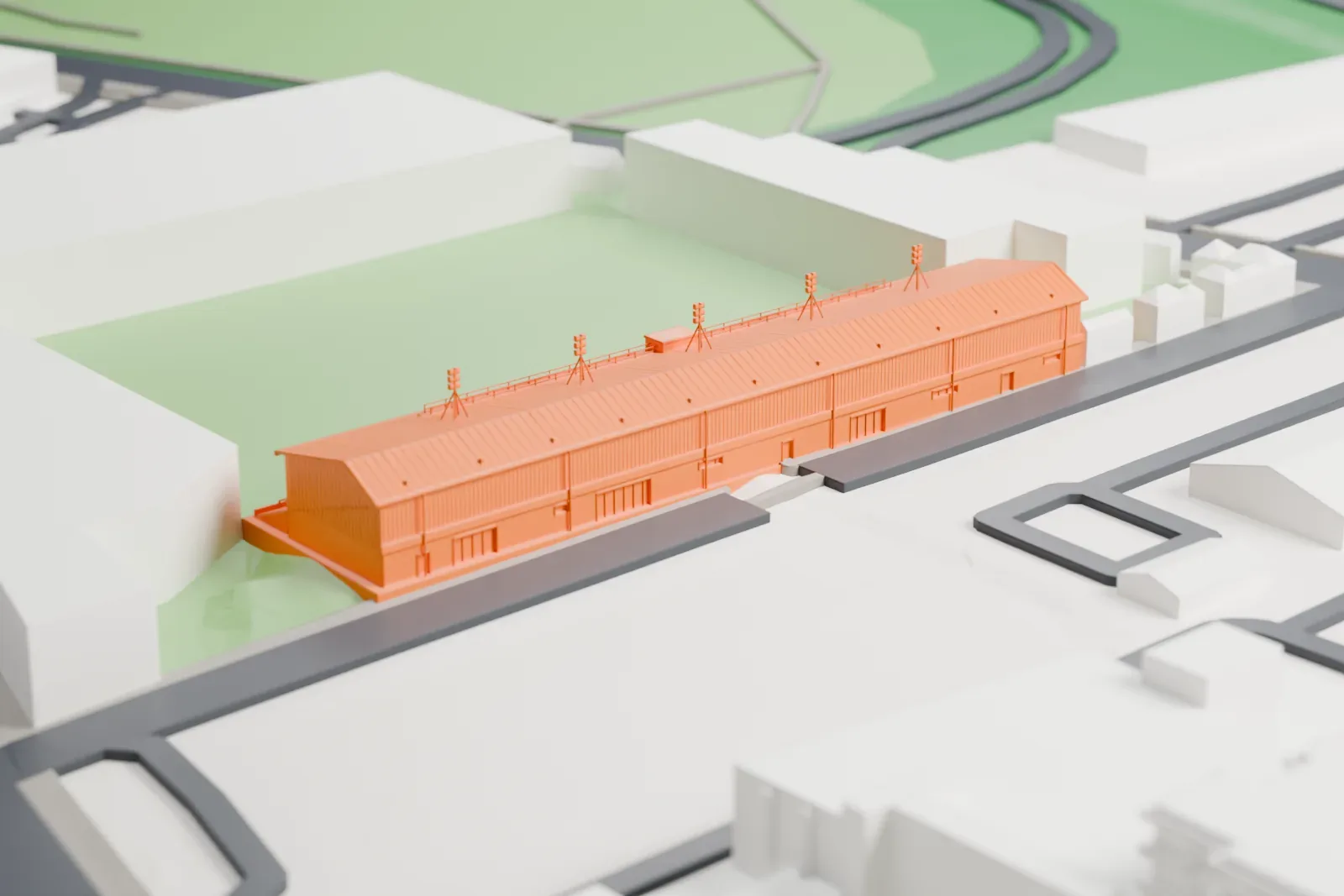 A white 3D print of Welford Road Stadium's long south stand, with a low pitched roof, open gallery and five floodlight frames, beside surrounding streets and buildings.