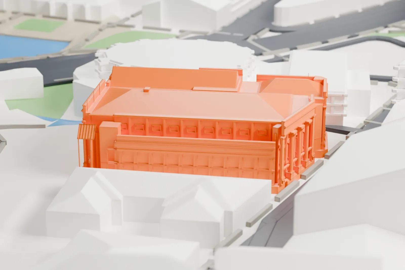 A white 3D print of the Wellington Town Hall, a richly detailed building with several overlapping hipped roofs, standing among nearby buildings and roads.