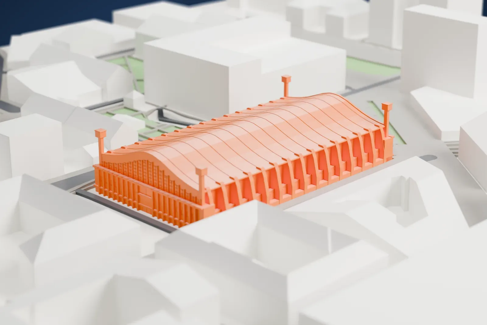 A white 3D print of Wembley Arena, a broad low building among the surrounding streets and buildings of the Wembley Park area.