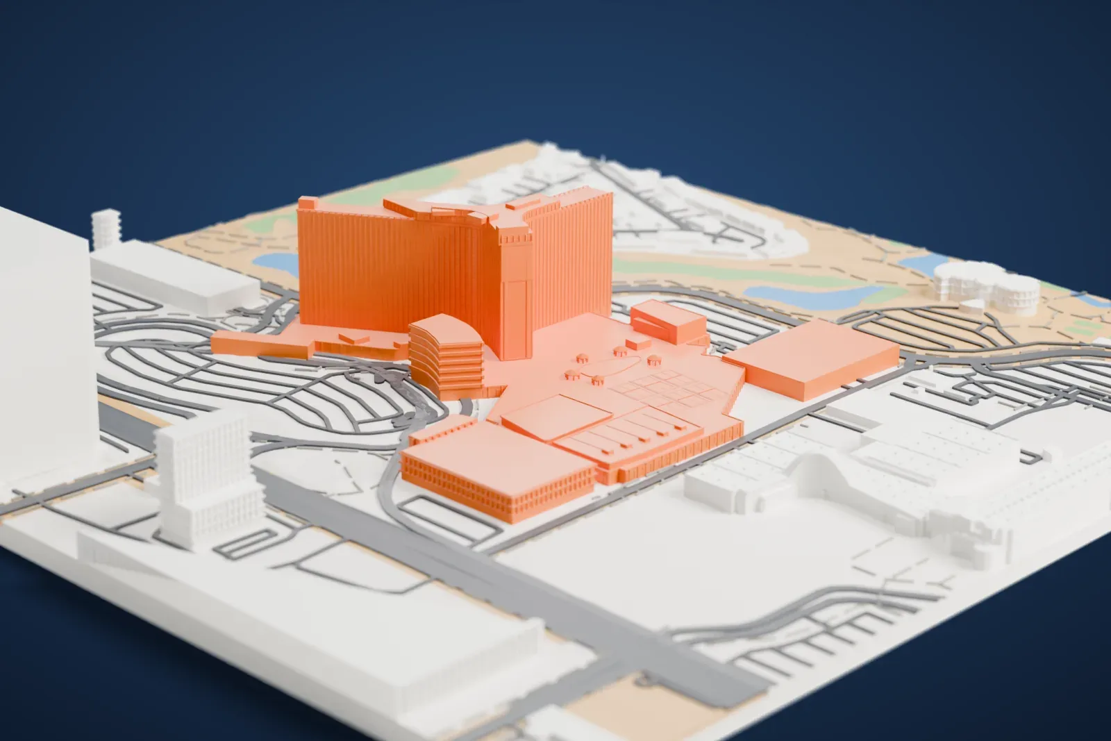 A white 3D print of the Westgate Las Vegas, a Y-shaped hotel tower rising from a low podium with a pool deck, surrounded by large buildings, roads, ponds and park-like green.