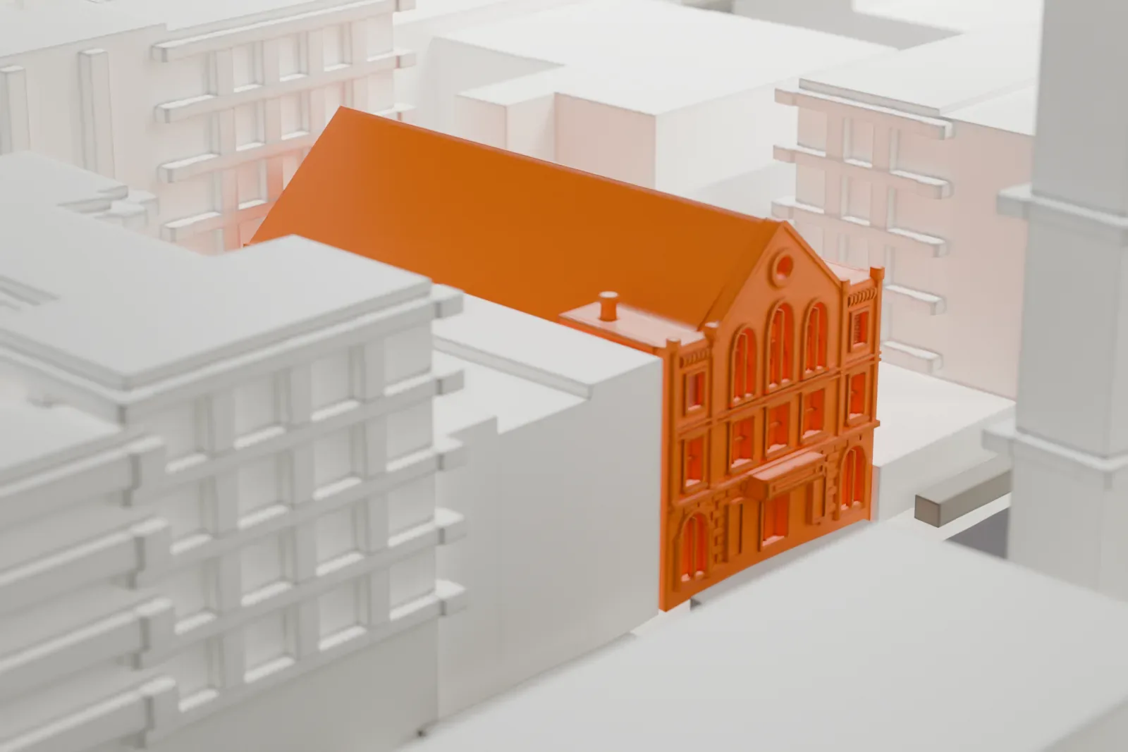 A white 3D print of the Westside Theatre, a hall with a long pitched roof and an arched-window front, between taller buildings.