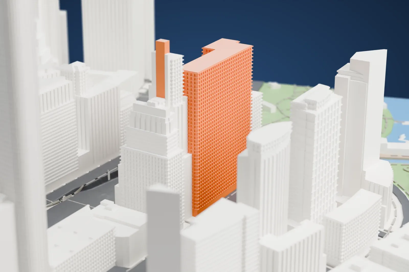 A white 3D print of the Whitehall Building Annex, a tall, ornate tower with arched windows and a rooftop water tank, among taller neighbors beside a green park edge.