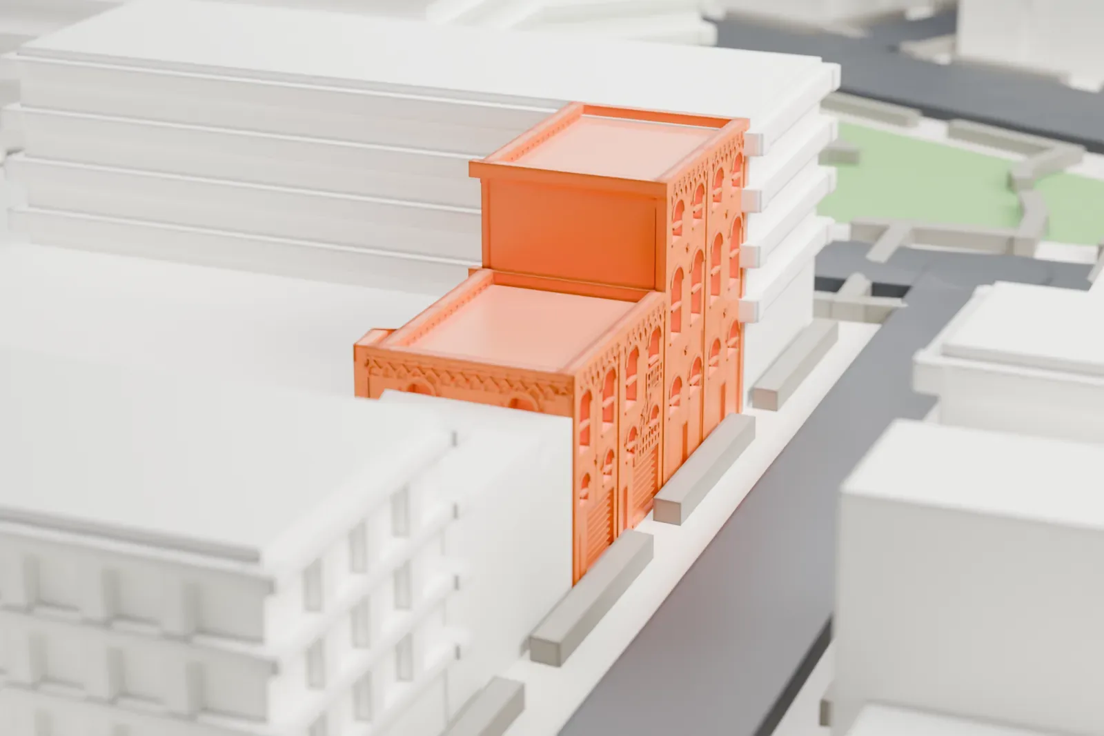 A white 3D print of the William Ulmer Brewery, a cluster of arched-window buildings of different heights, hemmed in by larger neighboring buildings.