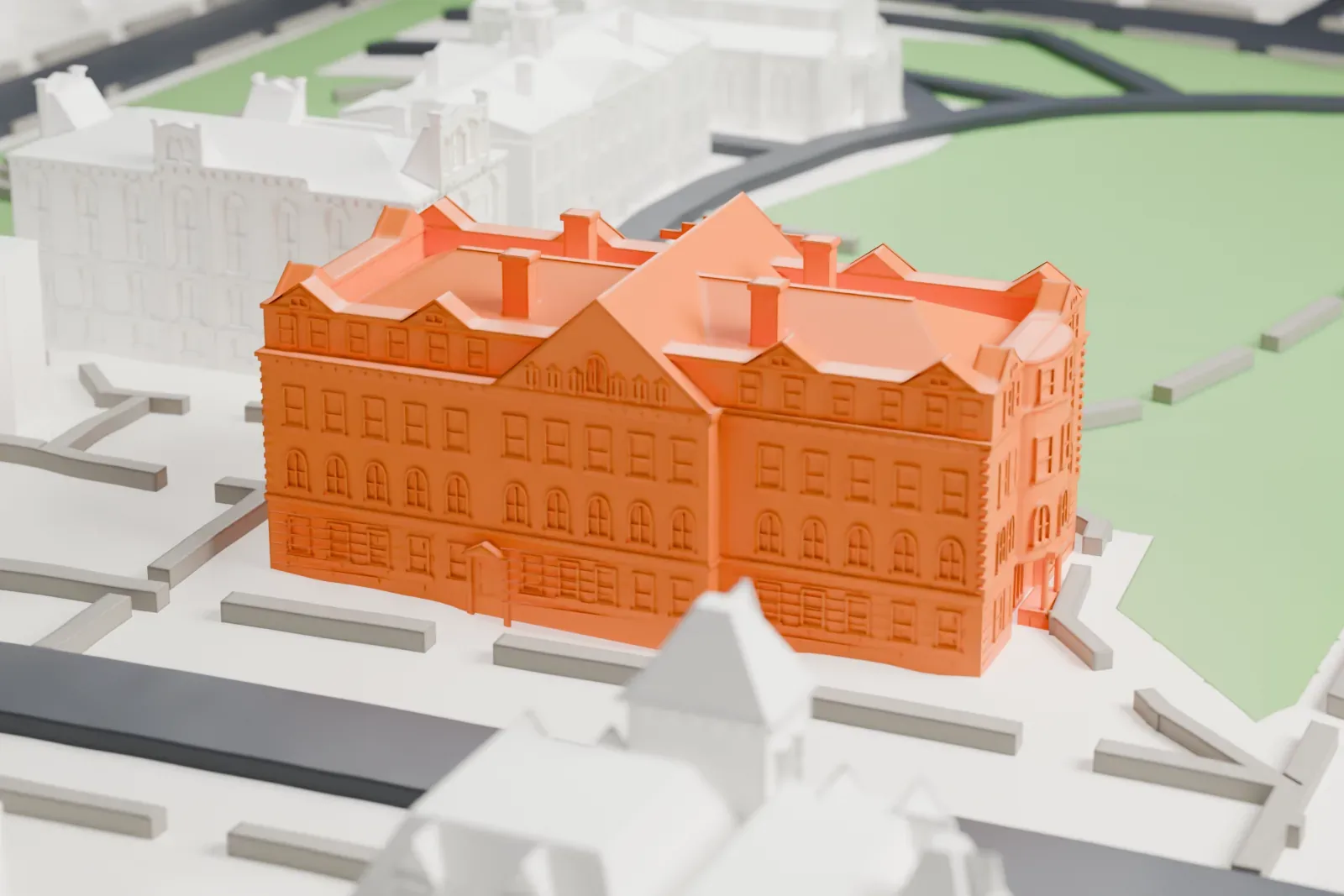 A white 3D print of Winants Hall, a large building with many gables, dormers and chimneys, set on a green campus with paths and neighboring buildings.