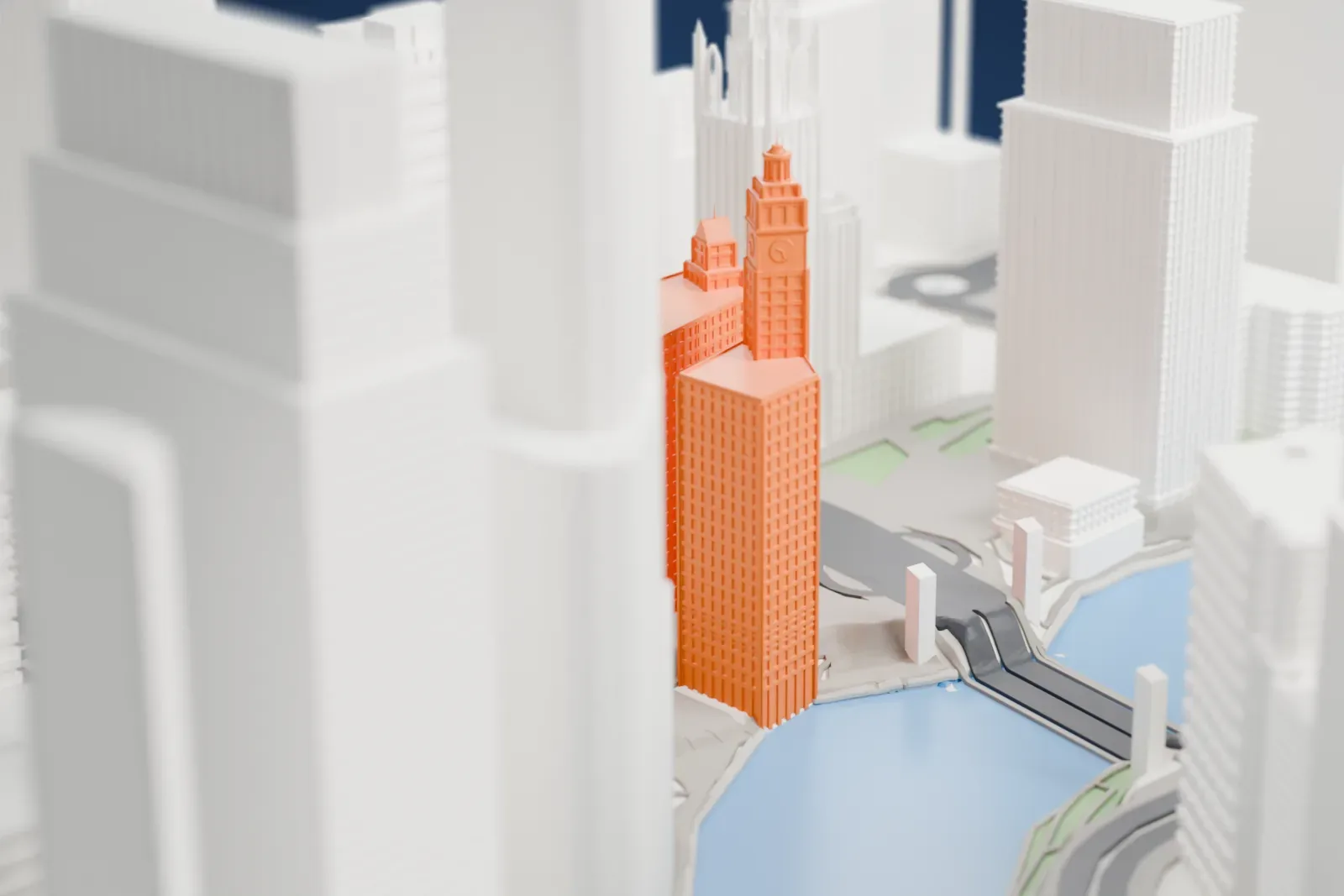 A white 3D print of the Wrigley Building, with the surrounding streets and buildings of Chicago around it.