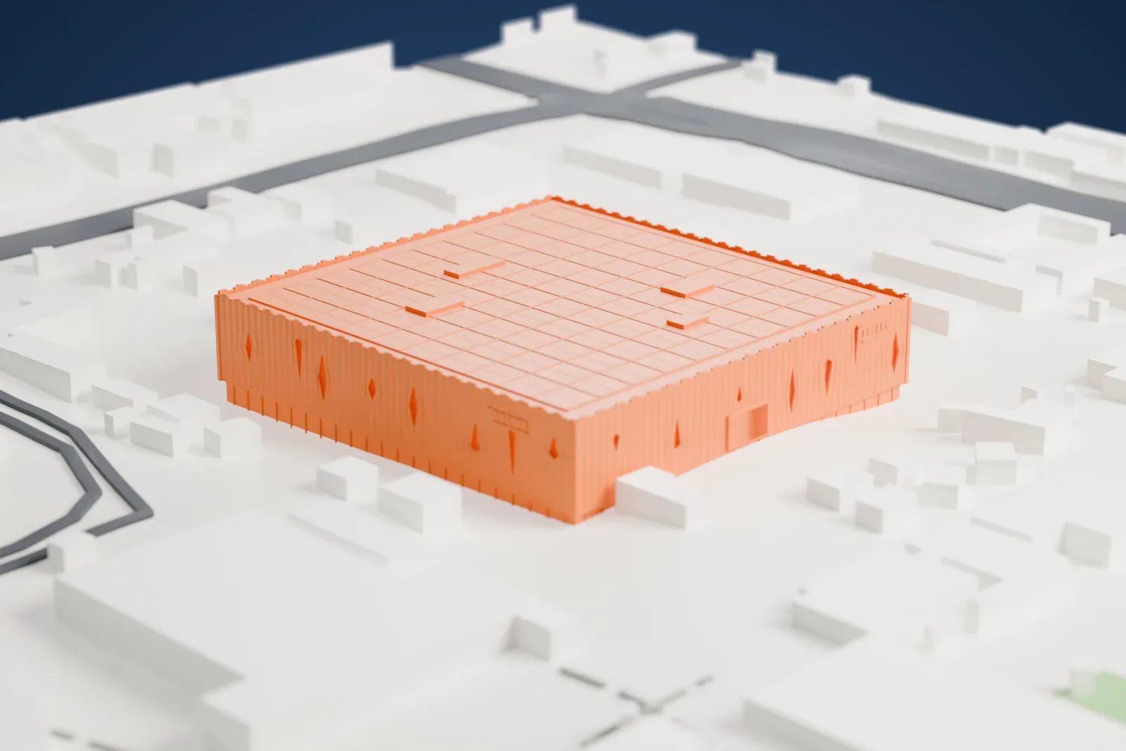 A white 3D print of the Wukesong Arena, a low square box wrapped in a curtain of vertical tubes with a ragged top edge and a flat roof, among the surrounding streets and buildings.