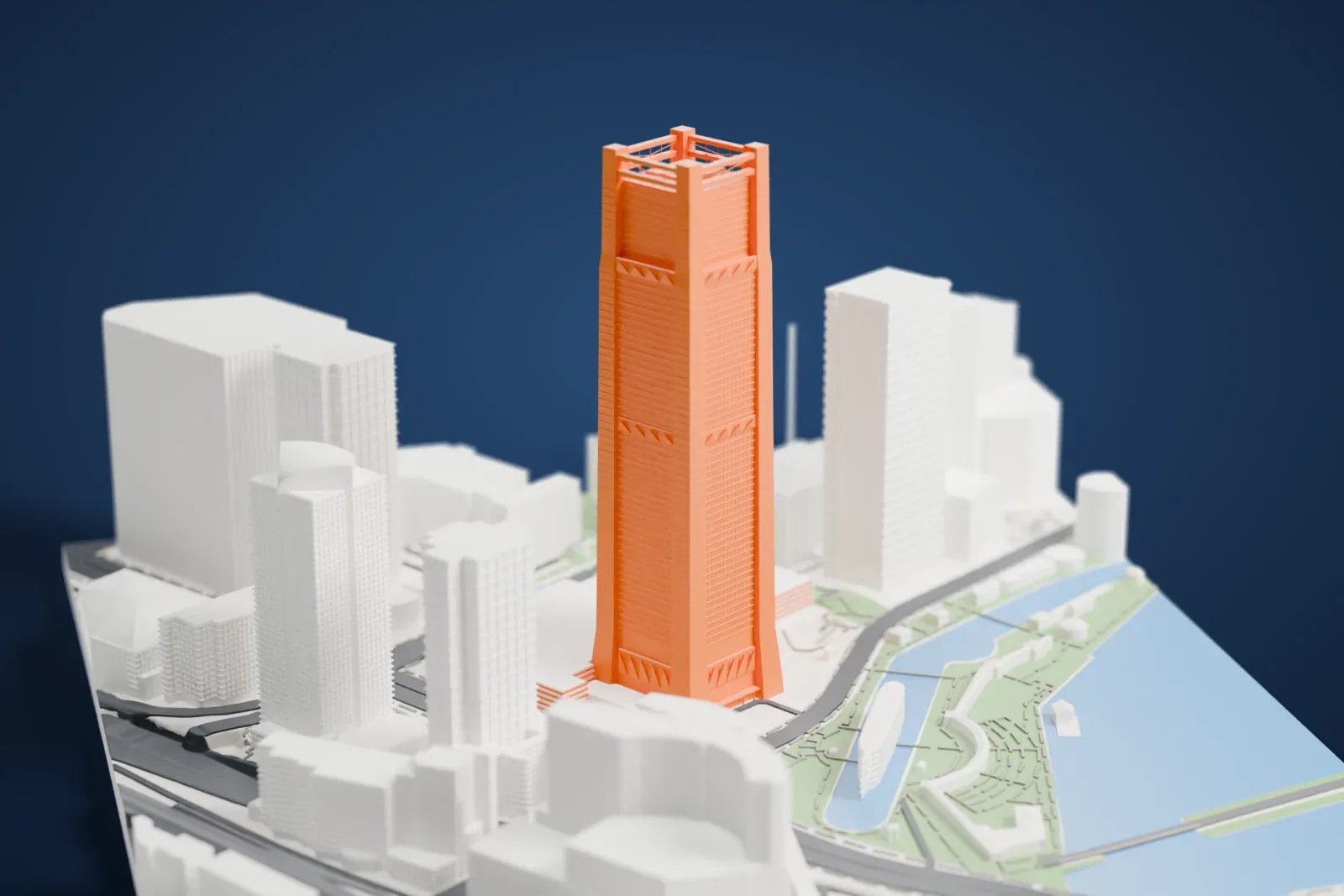 A white 3D print of the Yokohama Landmark Tower, a very tall, slim tower with an open-frame crown, standing among tall buildings with a waterfront and green park paths nearby.