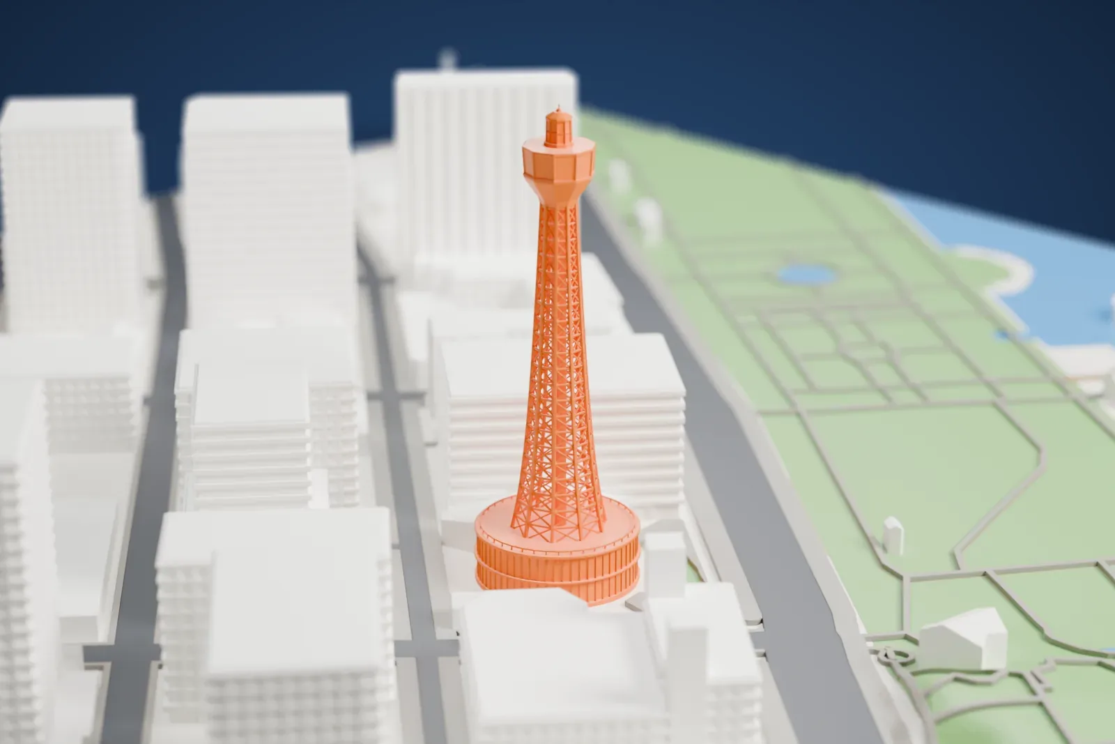 A white 3D print of the Yokohama Marine Tower, a tall lattice tower, among surrounding streets and buildings.