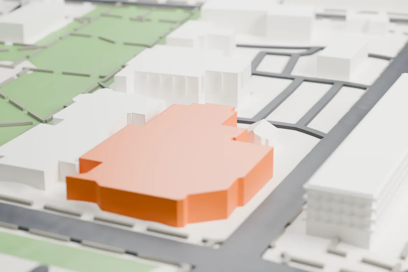 A white 3D print of the Zimmerli Art Museum, a wide, low building with flat, stepped roofs, surrounded by campus lawns, roads and larger buildings.