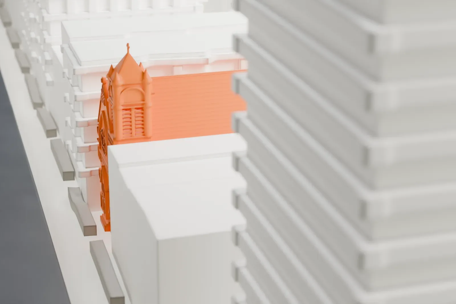 A white 3D print of Zion-St. Mark's Church, a long gabled church with a square tower under a pyramid roof, almost hidden among much taller buildings.