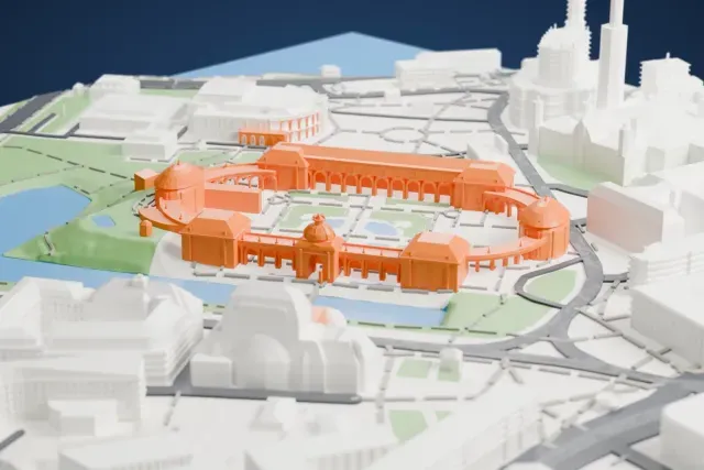 A white 3D print of the Zwinger Palace, a horseshoe of long gallery wings, open arcades and domed pavilions around a garden courtyard, beside a pond and surrounded by streets and city buildings.