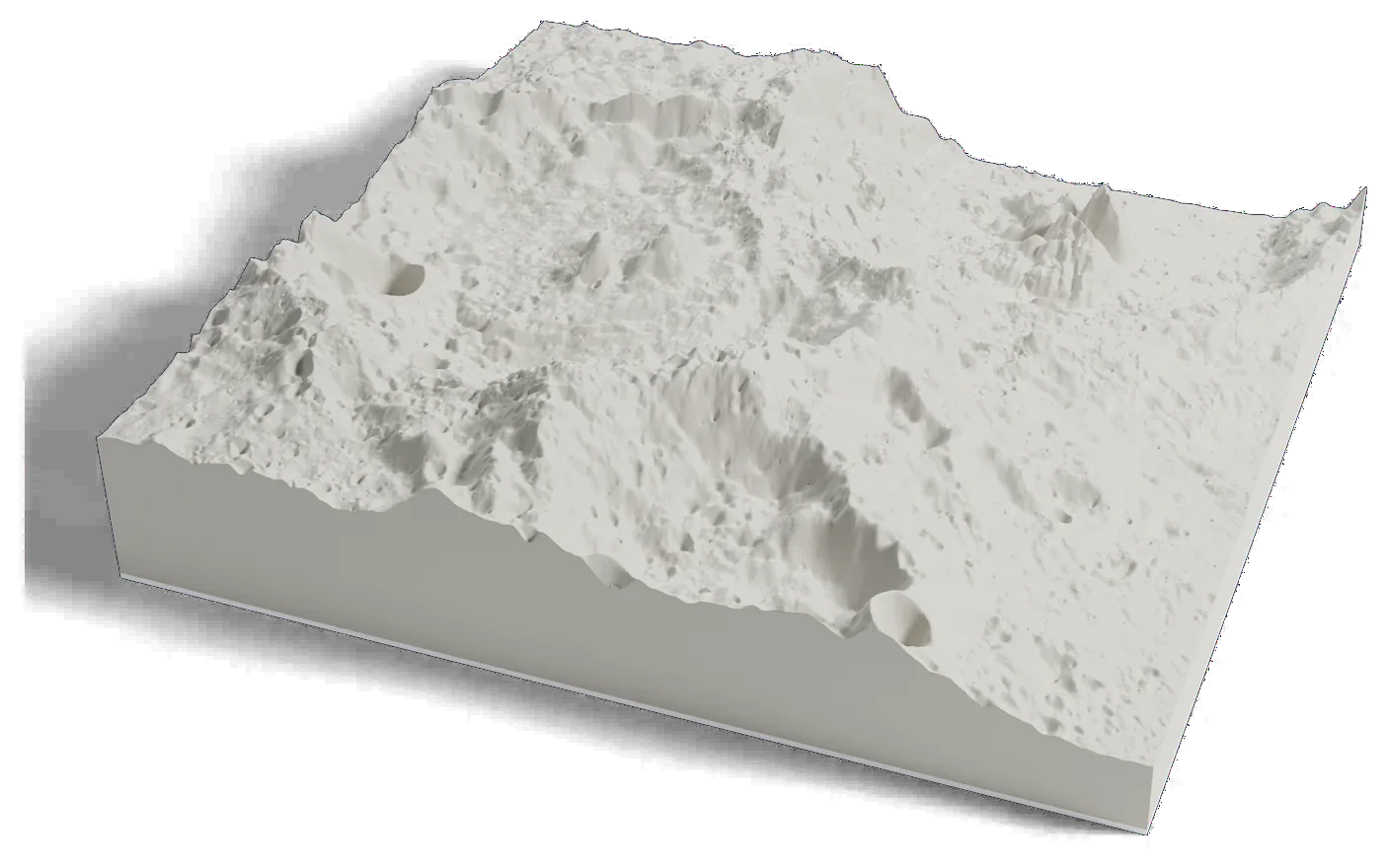3D printed relief map of the area around the SLIM landing site on the Moon, between the steep walls of two large craters.