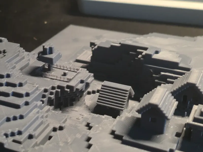 3D printed Minecraft build in gray filament with stone stairs, walls and a small house.