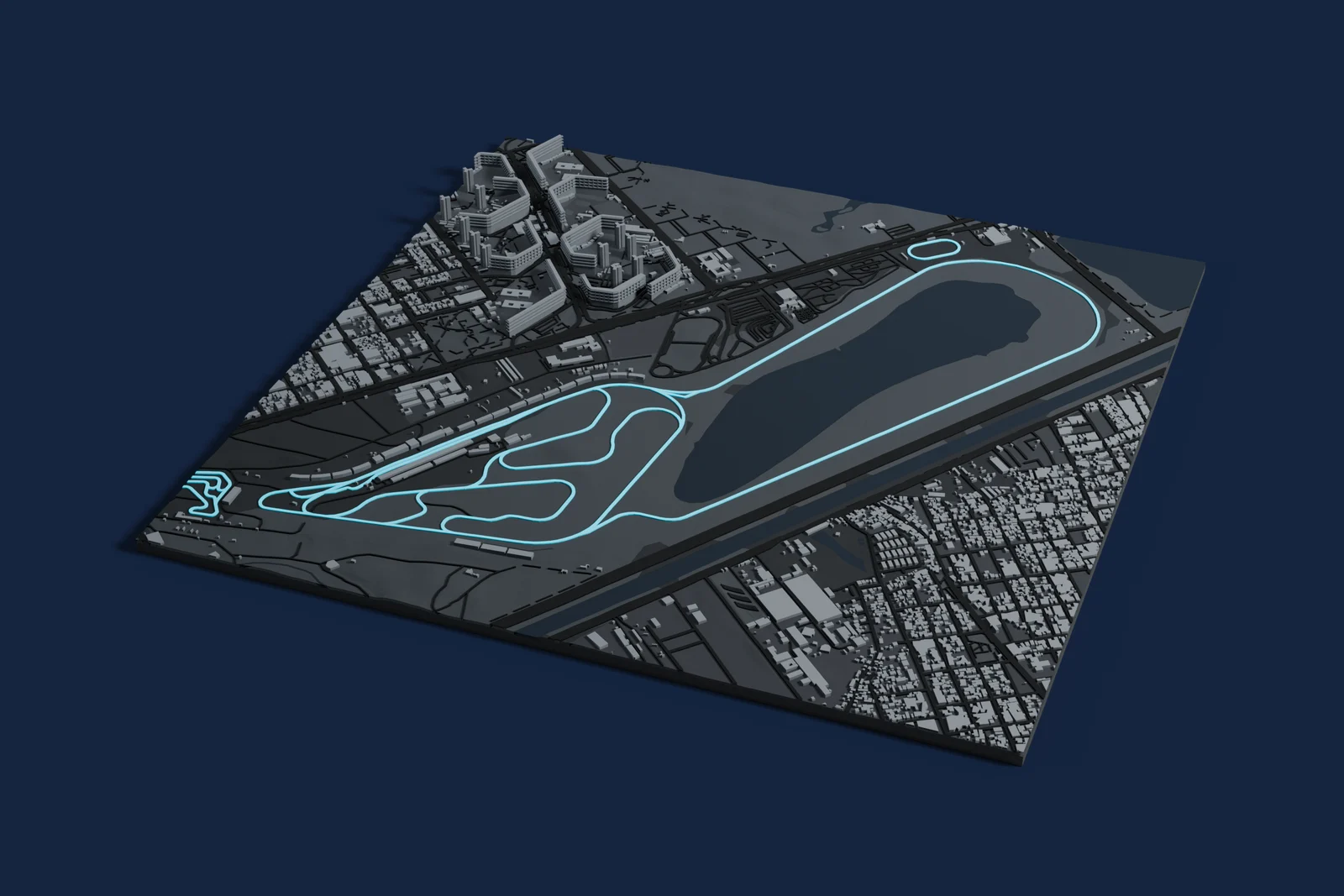 Render of a 3D printed map of Autódromo Oscar y Juan Gálvez, the track in cyan on a dark grey model of the land and buildings around it.