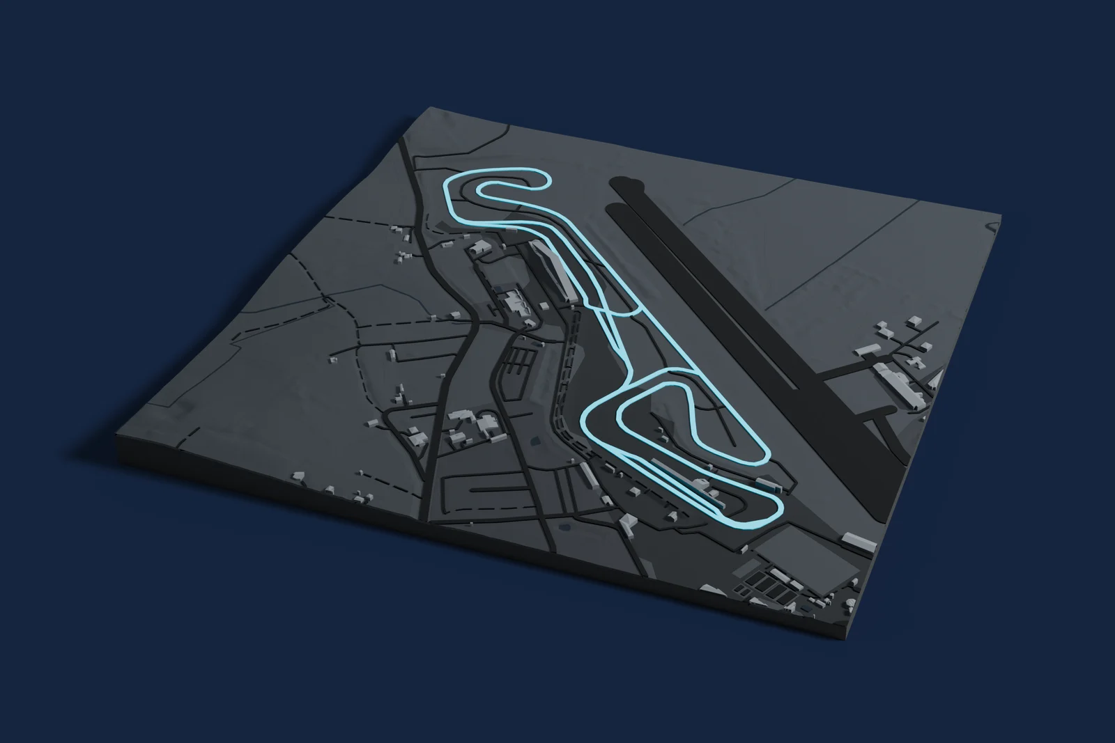Render of a 3D printed map of Circuit Paul Armagnac, the track in cyan on a dark grey model of the land and buildings around it.