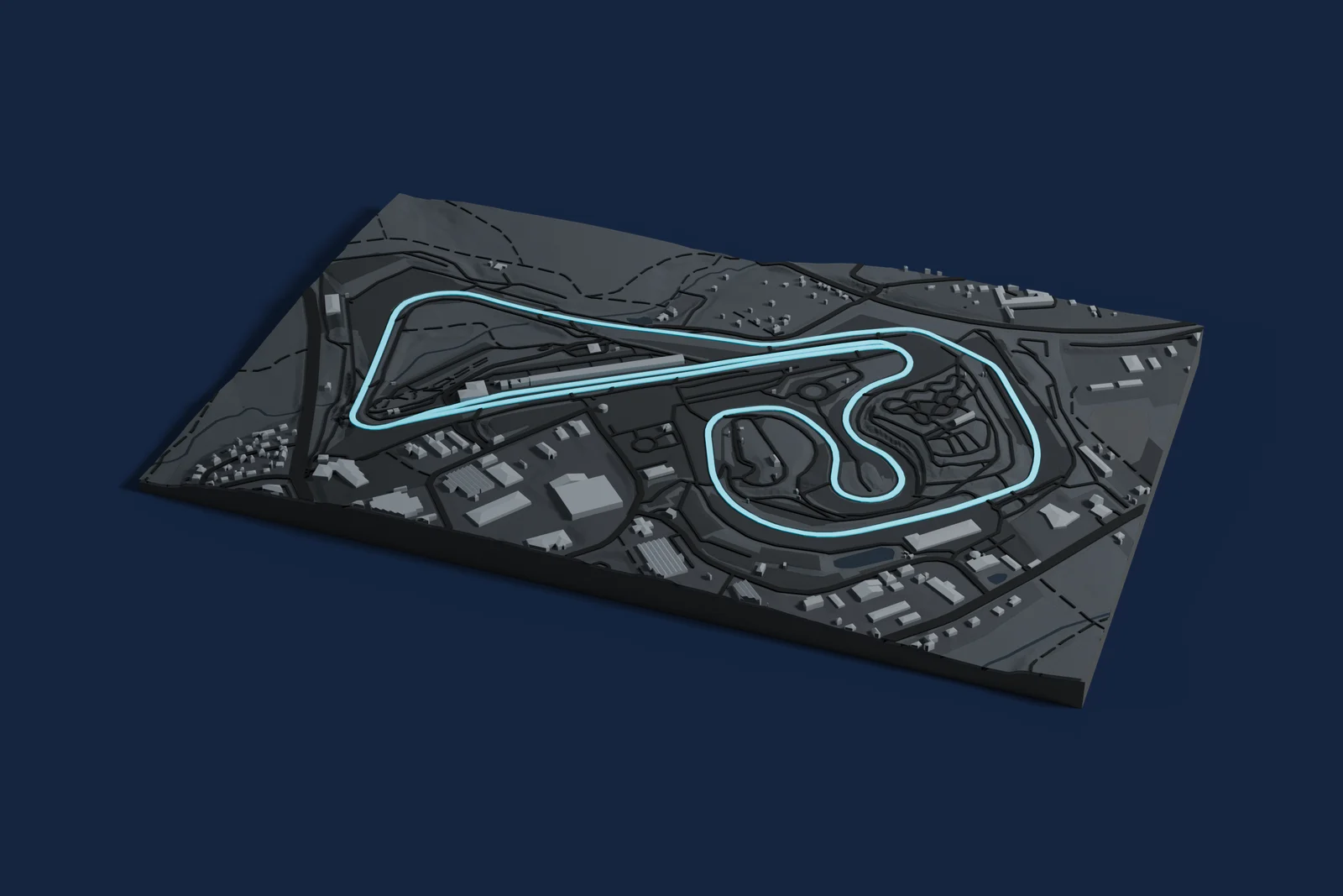 Render of a 3D printed map of Sachsenring, the track in cyan on a dark grey model of the land and buildings around it.